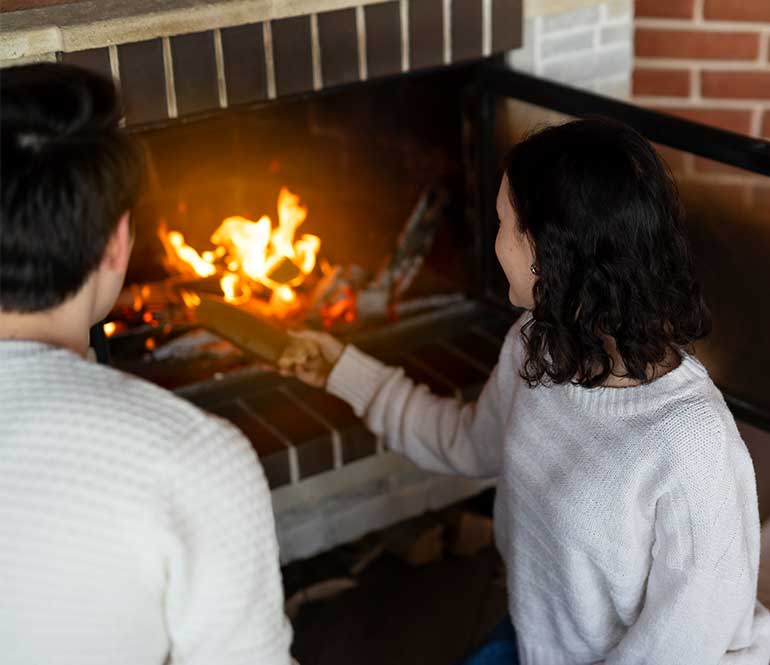 Man and Woman enjoying a Fireplace